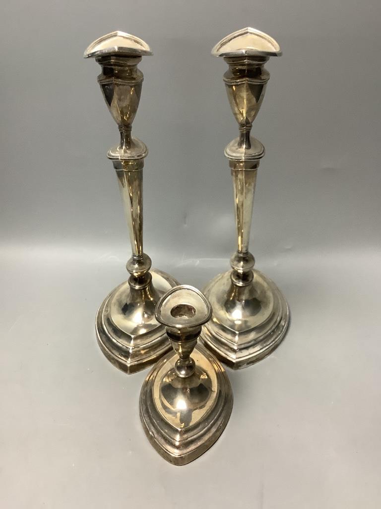 A pair of Mappin & Webb George III style silver candlesticks and a similar dwarf candlestick, H 30cm & 11cm